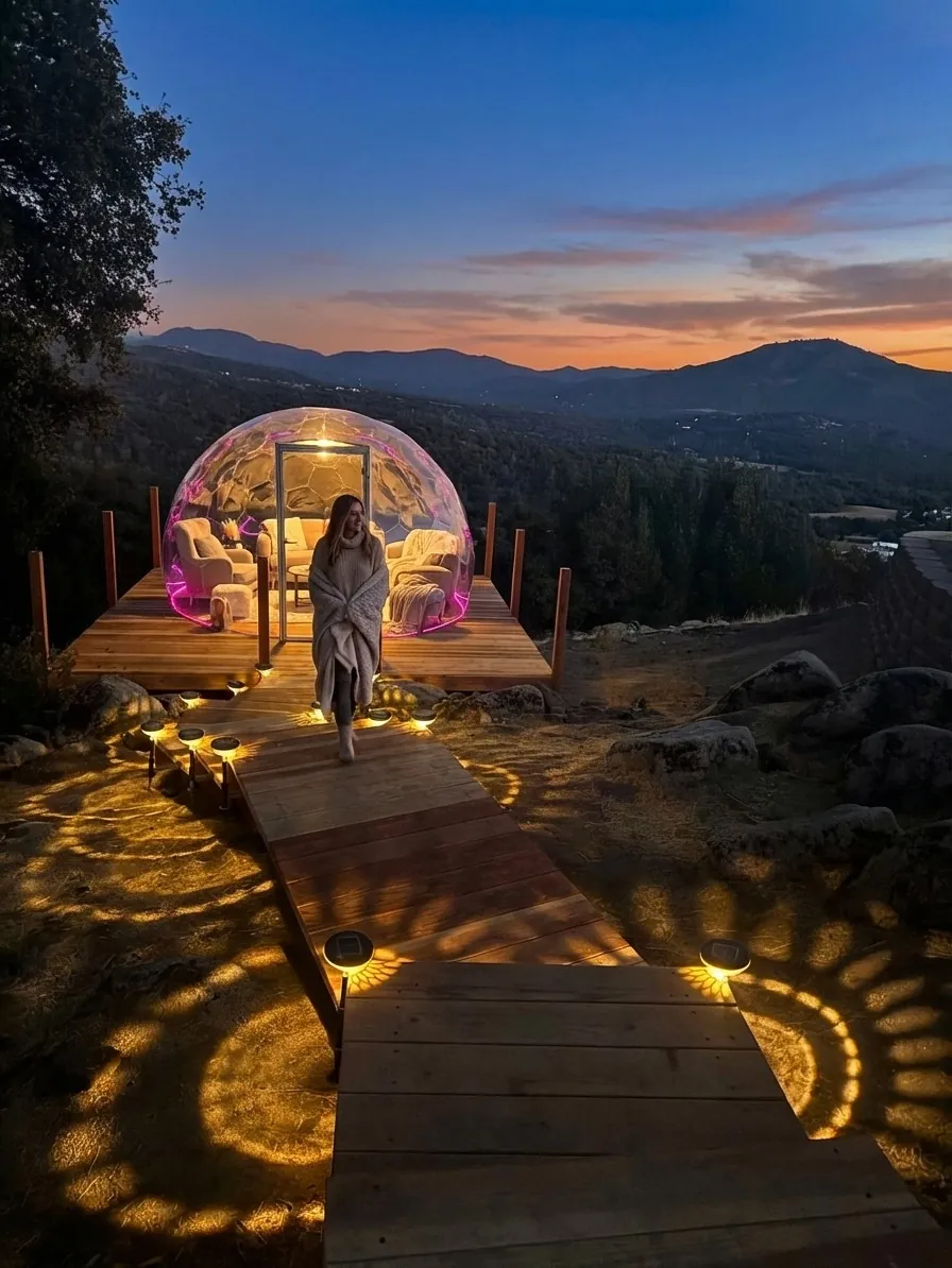 Cover photo example: geodesic dome at sunset with warm interior lighting and mountain walkway approach
