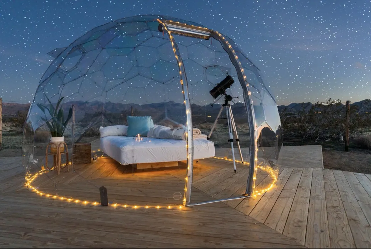 A Hypedome lit softly inside, the surrounding garden dark for stargazing